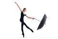 A young ballerina in black pointe shoes and leotard posing with umbrella in graceful pose isolated on white background