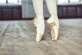 Feet in Pointe shoes on the floor Royalty Free Stock Photo