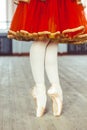 Feet in Pointe shoes on the floor Royalty Free Stock Photo