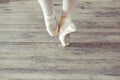 Feet in Pointe shoes on the floor Royalty Free Stock Photo