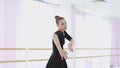 Young ballerina makes beautiful movements with her hands.