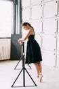 Young ballerina standing on poite at barre in ballet class