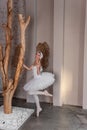 Young ballerina in white tutu with joyful smile fooling around, captures the whimsy of dance