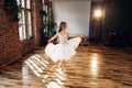 Young ballerina in white tutu practicing dance moves. Royalty Free Stock Photo