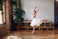 Young ballerina in white tutu practicing dance moves. Royalty Free Stock Photo