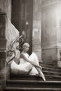 Young ballerina woman posing on stairs