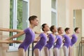 Young ballerinas doing exercises at barre. Royalty Free Stock Photo
