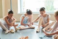 Young ballerinas tying pointe shoes. Royalty Free Stock Photo