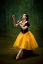 Young ballet dancer as a Snow White with poisoned apple in forest