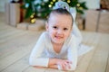 Young ballet dancer lying near Christmas tree Royalty Free Stock Photo