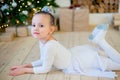 Young ballet dancer lying near Christmas tree Royalty Free Stock Photo