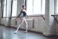 Young ballet dancer practice movement legs stratching in studio active lifestyle