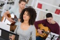 Young band music playing song in recording studio Royalty Free Stock Photo