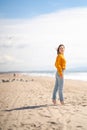 Young barefoot girl on the beach