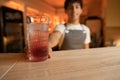 Young barman is making and serve cocktail at night club. Royalty Free Stock Photo