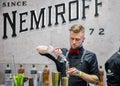 Young barman prepares Bloody Mary cocktail