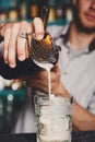 Young Barman`s making shot cocktail, pouring syrup into glass Royalty Free Stock Photo