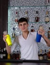 Young barman shaking two cocktail shakers Royalty Free Stock Photo