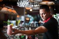 Young bartender with cocktail