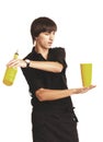 Young bartender with a shaker and bottle