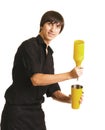 Young bartender with a shaker and bottle