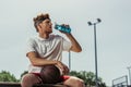 young basketball player drinking water from Royalty Free Stock Photo