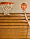 Cropped photo of Young basketball player dunking basketball in hoop Royalty Free Stock Photo