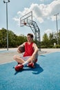 A young basketball player sits on Royalty Free Stock Photo
