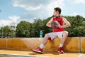 A young basketball player sitting on Royalty Free Stock Photo