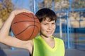 Young basketball player standing on the court wearing a yellow s Royalty Free Stock Photo