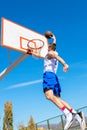 Young Basketball street player making slam dunk Royalty Free Stock Photo