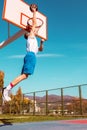 Young Basketball street player making slam dunk Royalty Free Stock Photo