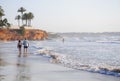 Young bather hits the roaring waves and elderly couple on a morn