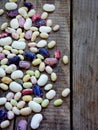 Young beans of different varieties and colors with a side border on a wooden background Royalty Free Stock Photo