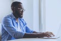 Young Beard Afro-american Man Working with Laptop. Royalty Free Stock Photo