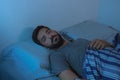 Young beard man lying on the bed awake