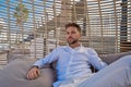 Young beard man relaxed in a beach parasol