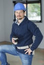 Young bearded builder drinking coffee