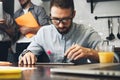 Young bearded business analyst conducts research on a computer t