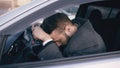 Young bearded business man sitting in car very upset and stressed after hard failure and moving in traffic jam Royalty Free Stock Photo