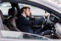 Sad businessman driving alone in his new car Royalty Free Stock Photo