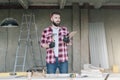 Young bearded businessman,builder,repairman,carpenter,architect, designer, on table construction tools. Royalty Free Stock Photo