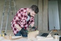 Young bearded businessman, builder, repairman, carpenter, architect, designer, handyman dressed in plaid shirt Royalty Free Stock Photo