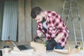 Young bearded businessman, builder, repairman, carpenter, architect, designer, handyman dressed in plaid shirt, goggles Royalty Free Stock Photo