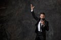 A young bearded businessman in a suit looks at the phone and rejoices. successful man saw good news on the phone, joy Royalty Free Stock Photo