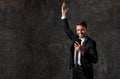 A young bearded businessman in a suit looks at the phone and rejoices. successful man saw good news on the phone, joy Royalty Free Stock Photo