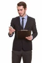 Young bearded businessman in suit using phone and holding clipboard Royalty Free Stock Photo