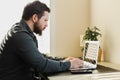 Young bearded businessman working in office, looking at laptop computer screen. Royalty Free Stock Photo