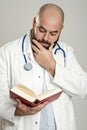 Young bearded doctor with book