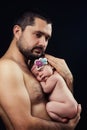 Young bearded father gently holds on his chest newborn baby daughter Royalty Free Stock Photo